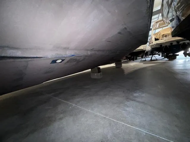 Slide: The Image of 2009 Sea Ray 350 Sundancer hull in storage, resting on supports. - 33