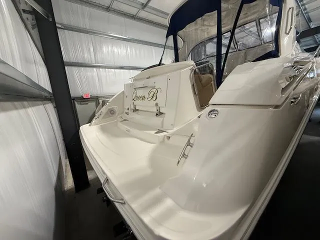 Slide: The Image of 2009 Sea Ray 350 Sundancer yacht in storage, featuring sleek white design and covered cockpit. - 4