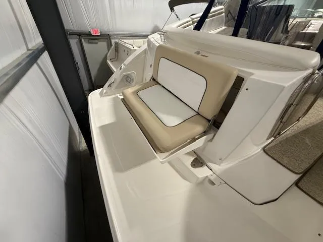 Slide: The Image of 2009 Sea Ray 350 Sundancer boat with beige and white seating in a storage facility. - 5