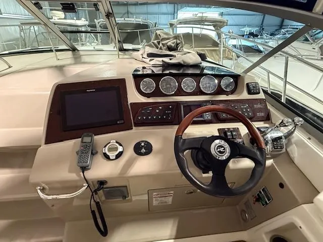 Slide: The Image of Cockpit of 2009 Sea Ray 350 Sundancer with steering wheel, gauges, and navigation equipment. - 7