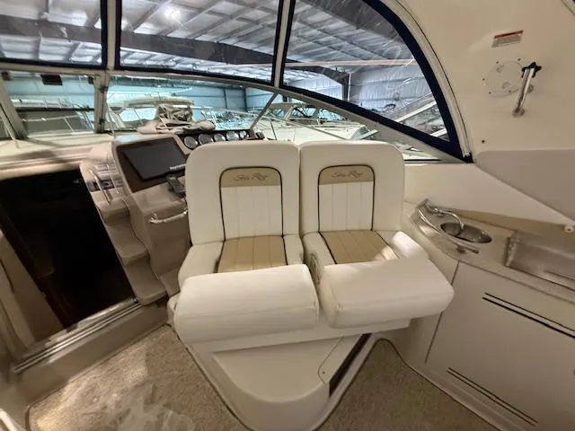 Slide: The Image of 2009 Sea Ray 350 Sundancer cockpit with dual seats and modern dashboard. - 8