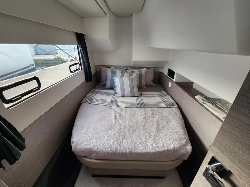 Slide: The Image of Cozy cabin interior of 2022 Fountaine Pajot MY4.S with bed and striped pillows. - 13