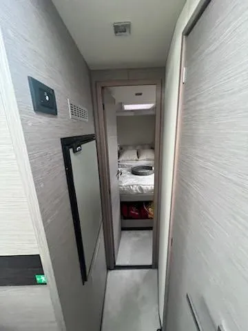 Slide: The Image of 2022 Fountaine Pajot MY4.S yacht interior hallway leading to a cozy bedroom. - 14