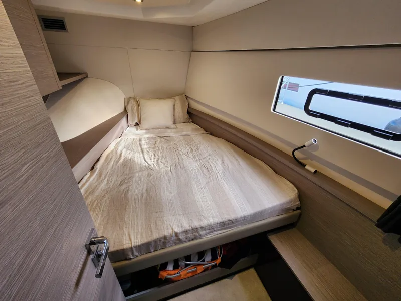 Slide: The Image of 2022 Fountaine Pajot MY4.S cabin interior with bed and window view. - 15