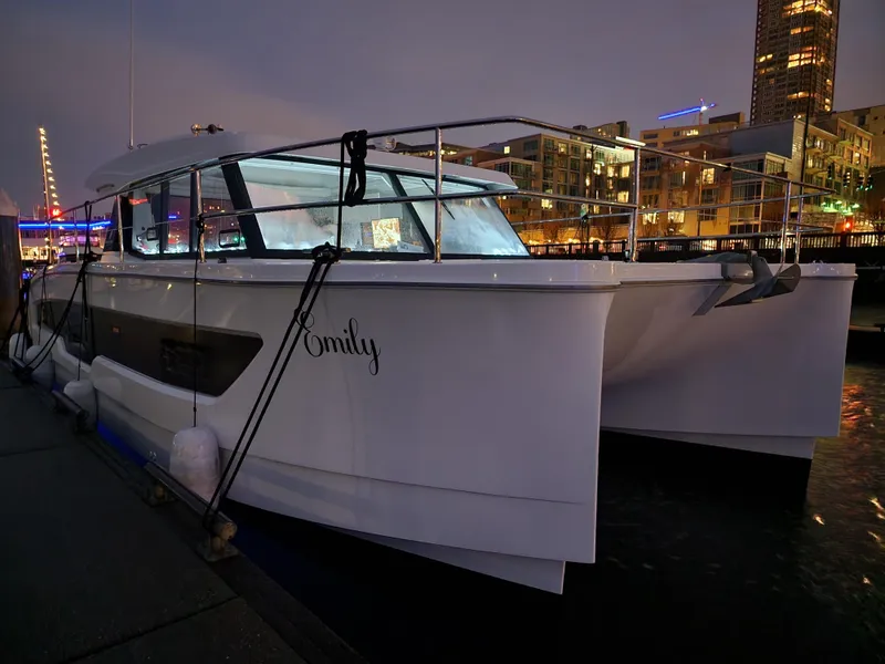 Slide: The Image of 2022 Fountaine Pajot MY4.S yacht docked at night in a city marina. - 18