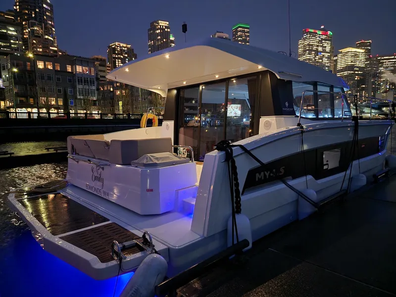 Slide: The Image of 2022 Fountaine Pajot MY4.S yacht docked at night with city skyline. - 20
