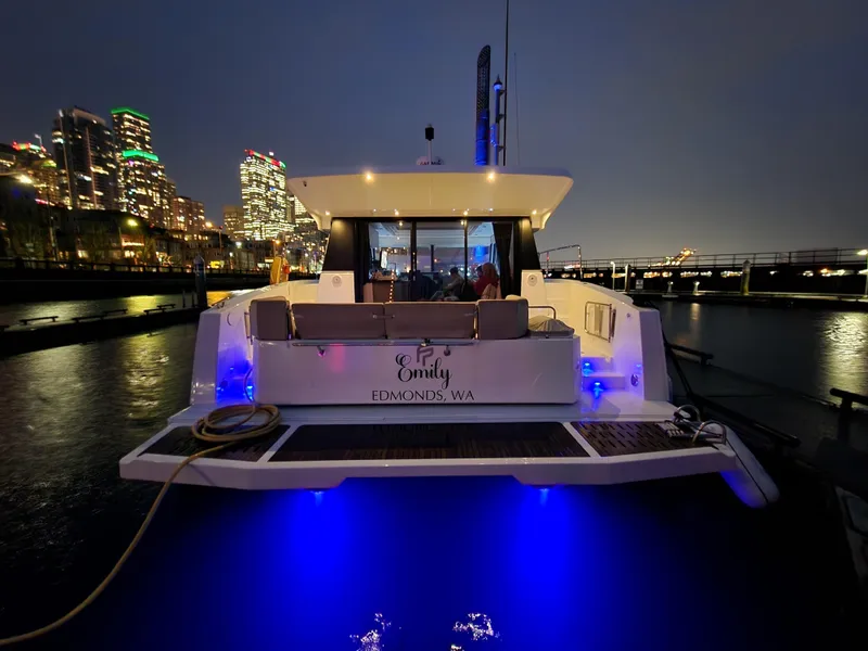 Slide: The Image of 2022 Fountaine Pajot MY4.S yacht docked at night, city skyline in background. - 21