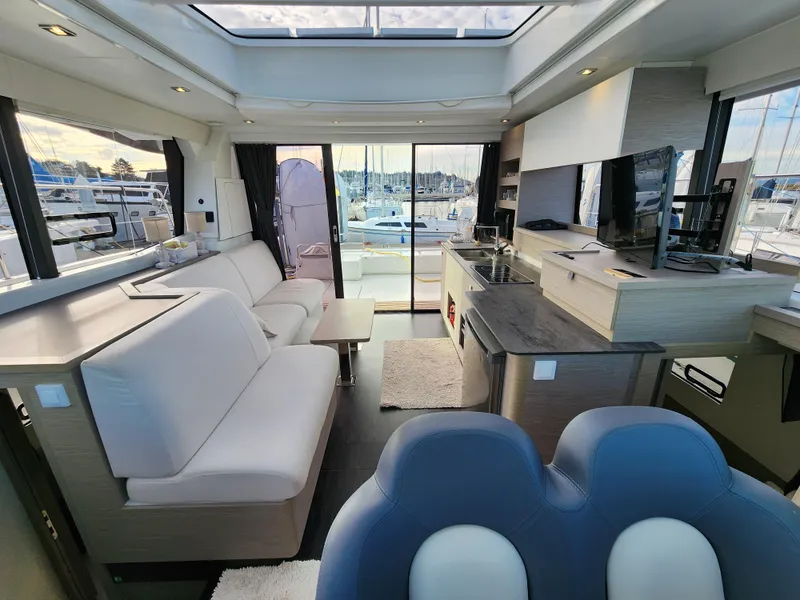 Slide: The Image of Luxurious interior of 2022 Fountaine Pajot MY4.S yacht with modern furnishings and marina view. - 5