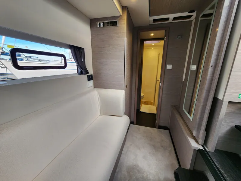 Slide: The Image of Interior of 2022 Fountaine Pajot MY4.S yacht, featuring a modern seating area and hallway. - 8