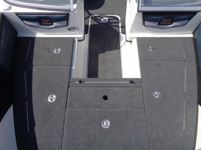 Slide: The Image of 2024 Ranger 1850MS boat interior with gray carpet and storage compartments. - 11