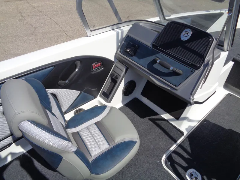 Slide: The Image of 2024 Ranger 1850MS boat interior with gray and blue seating, dashboard, and steering wheel. - 13