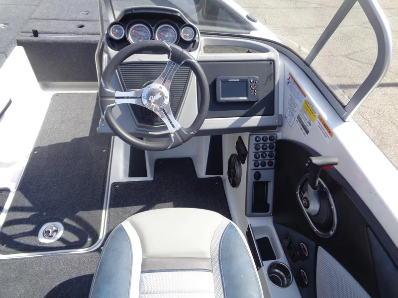 Slide: The Image of 2024 Ranger 1850MS boat cockpit with steering wheel, gauges, and control panel. - 16