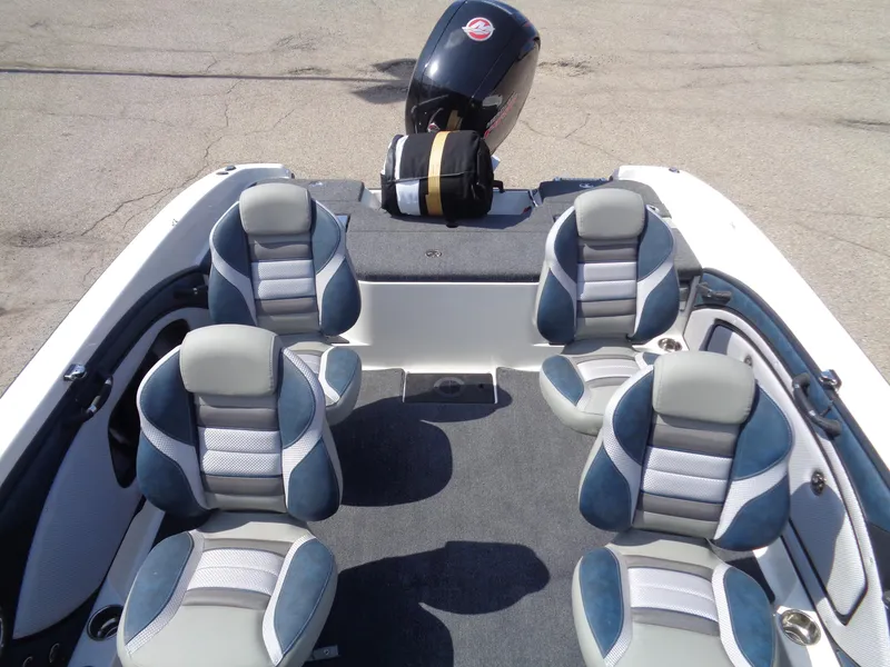 Slide: The Image of 2024 Ranger 1850MS boat interior with four cushioned seats and an outboard motor. - 7