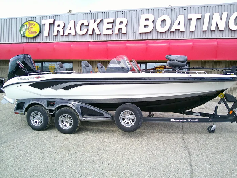 Slide: The Image of 2024 Ranger 620FS Pro boat on trailer outside Tracker Boating store. - 2