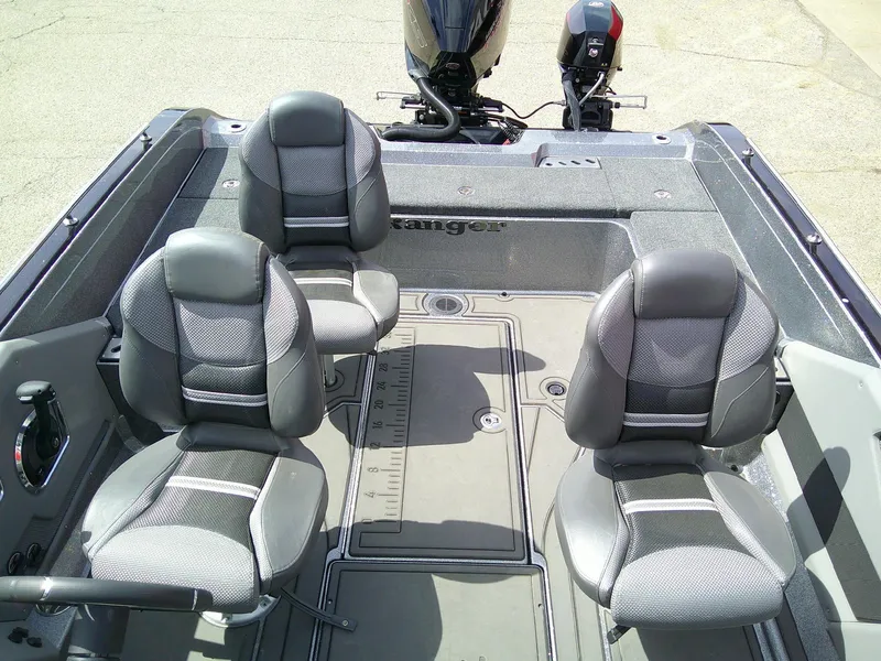 Slide: The Image of 2024 Ranger 620FS Pro boat interior with four cushioned seats and motor. - 7