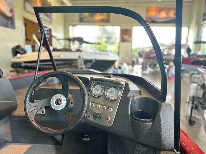 Slide: The Image of 2025 Tracker Pro Guide V-16 WT dashboard with steering wheel and gauges in showroom. - 3