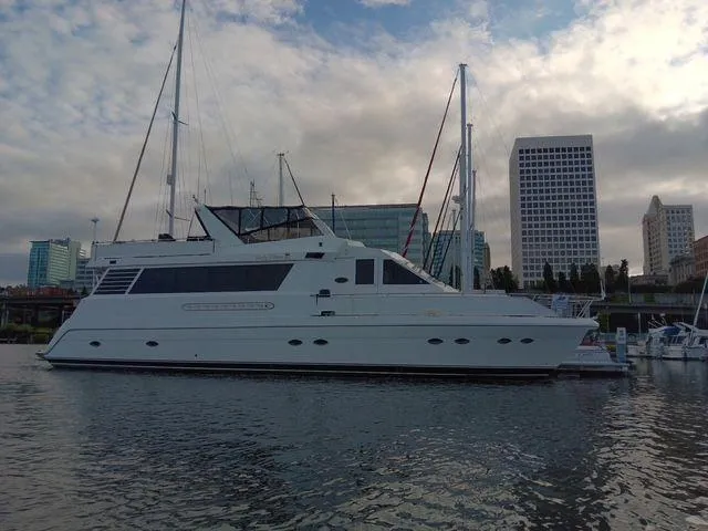Slide: The Image of 1993 Kha Shing Motoryacht docked in urban marina with city skyline backdrop. - 1