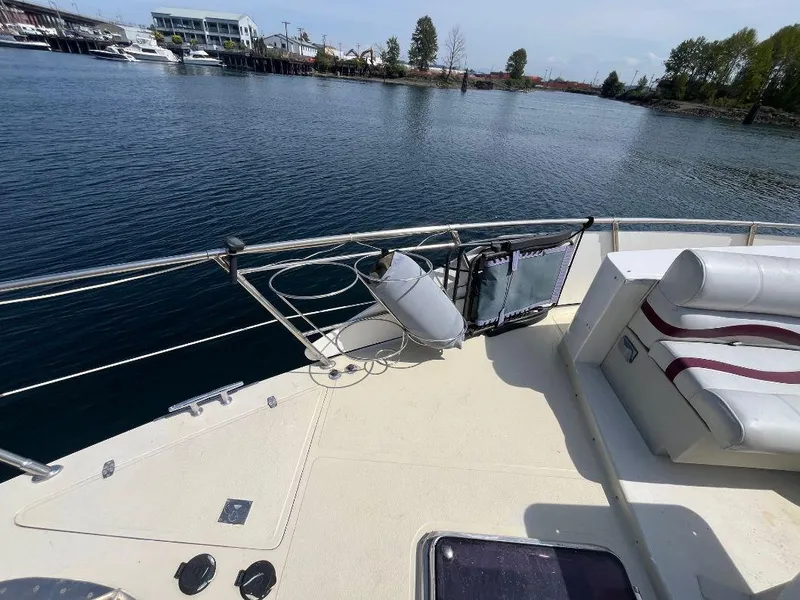 Slide: The Image of 1993 Kha Shing Motoryacht deck with seating, docked by calm waters. - 16