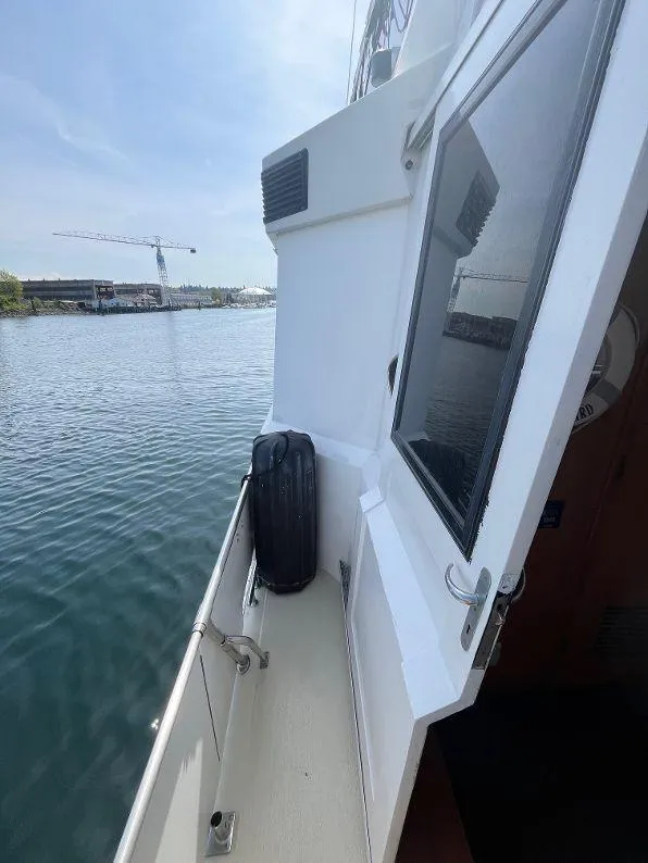 Slide: The Image of 1993 Kha Shing Motoryacht deck view with water and crane in the background. - 18