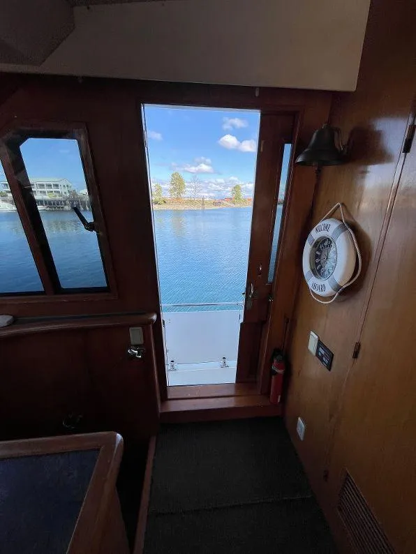Slide: The Image of Interior view of 1993 Kha Shing Motoryacht with open door to scenic water view. - 19