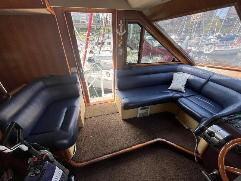 Slide: The Image of Interior of 1993 Kha Shing Motoryacht with blue leather seating and marina view. - 20