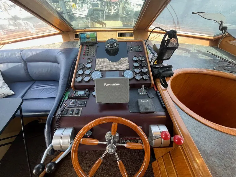 Slide: The Image of Cockpit of 1993 Kha Shing Motoryacht with wooden steering wheel and navigation equipment. - 23