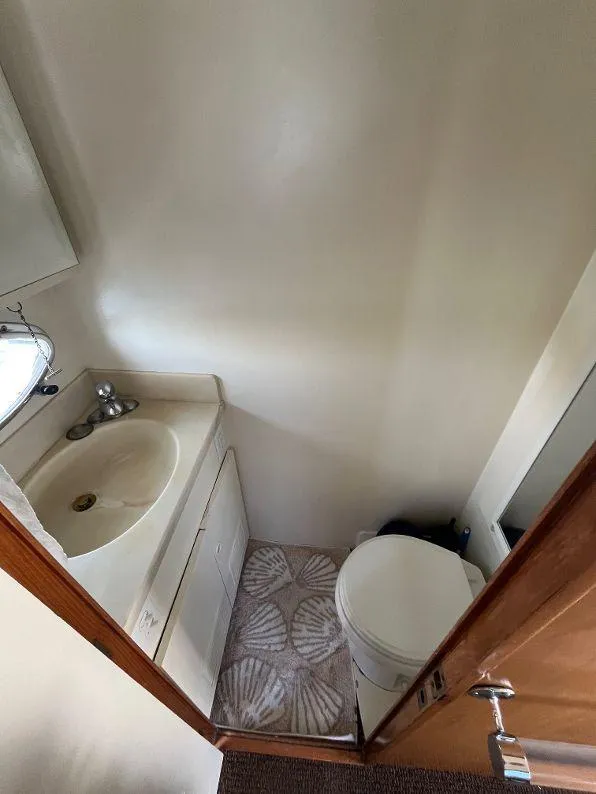 Slide: The Image of 1993 Kha Shing Motoryacht bathroom with sink, toilet, and shell-patterned floor. - 28