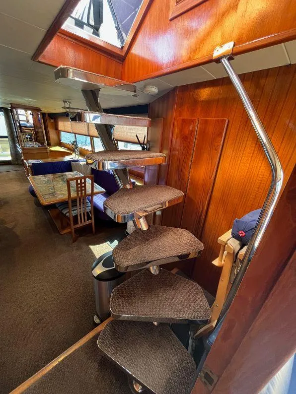 Slide: The Image of Interior of 1993 Kha Shing Motoryacht with spiral staircase and dining area. - 30