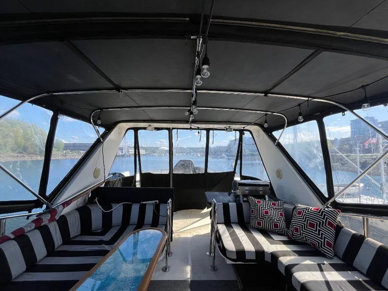 Slide: The Image of Interior of 1993 Kha Shing Motoryacht with striped seating and scenic water view. - 32