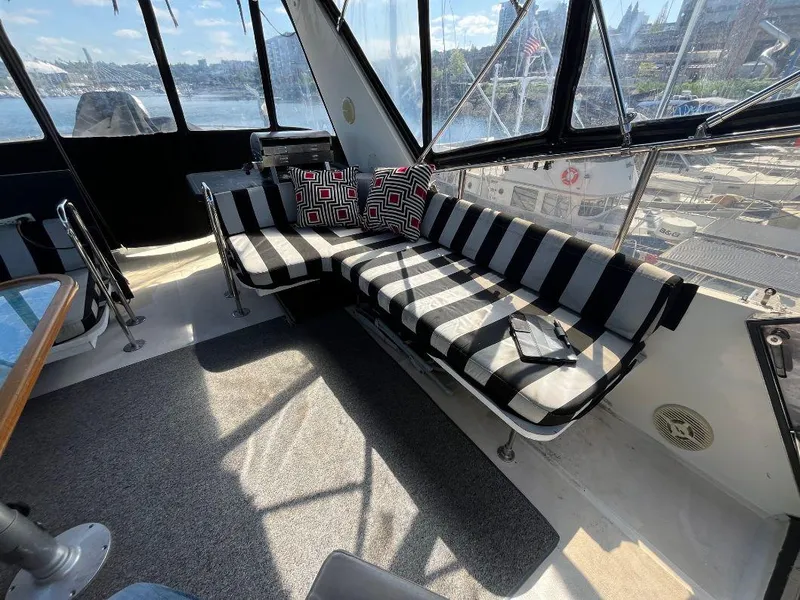 Slide: The Image of Interior of 1993 Kha Shing Motoryacht with striped seating and scenic window views. - 33