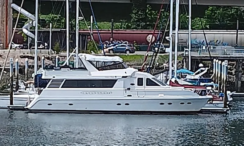 Slide: The Image of 1993 Kha Shing Motoryacht docked in a marina, surrounded by other boats. - 4