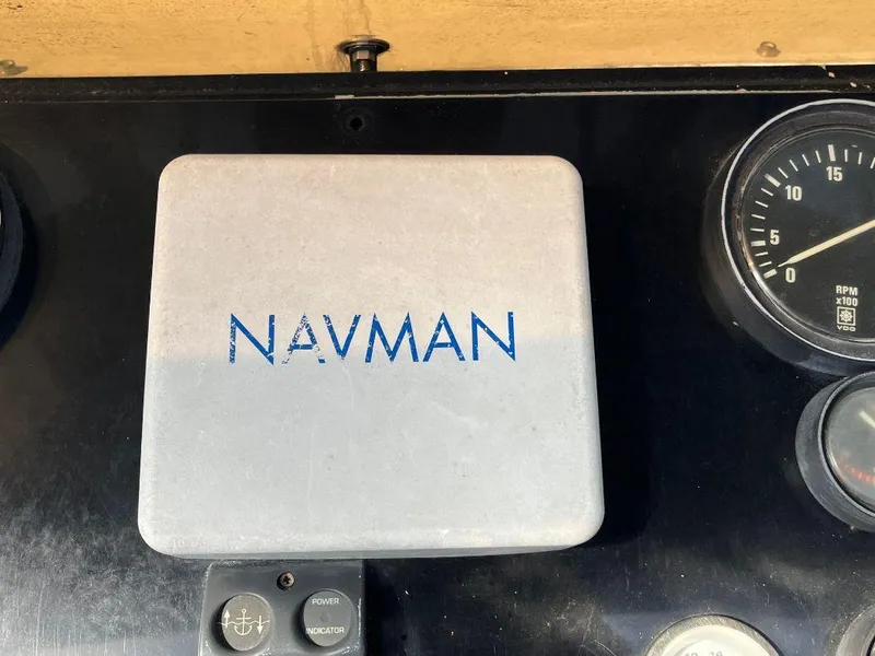 Slide: The Image of Navman device on 1993 Kha Shing Motoryacht dashboard with gauges and controls. - 45