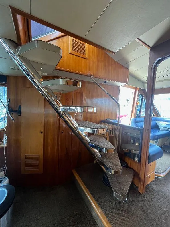 Slide: The Image of Interior of 1993 Kha Shing Motoryacht with wooden stairs and seating area. - 49