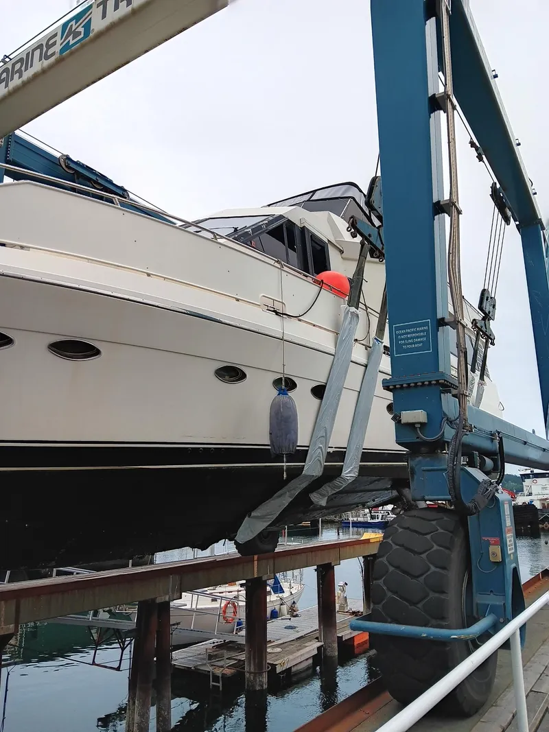 Slide: The Image of 1993 Kha Shing Motoryacht being lifted by a boat hoist at a marina. - 5