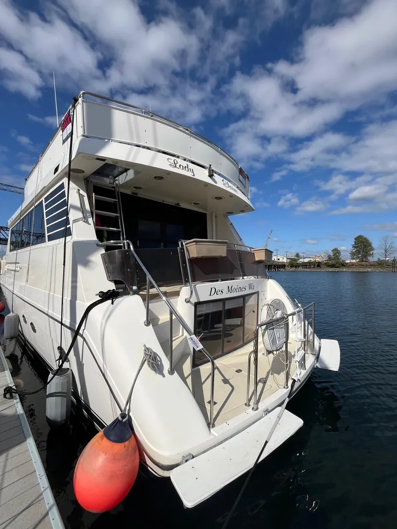 Slide: The Image of 1993 Kha Shing Motoryacht docked under a partly cloudy sky. - 6