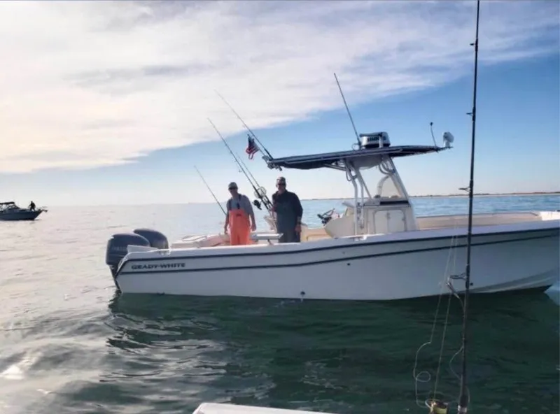 Slide: The Image of 2005 Grady-White Release 283 boat with two people fishing on calm water. - 1