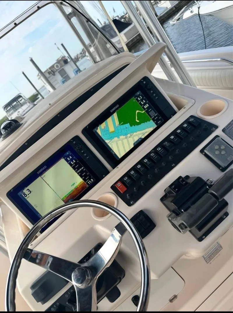 Slide: The Image of 2005 Grady-White Release 283 boat dashboard with navigation screens and controls. - 3