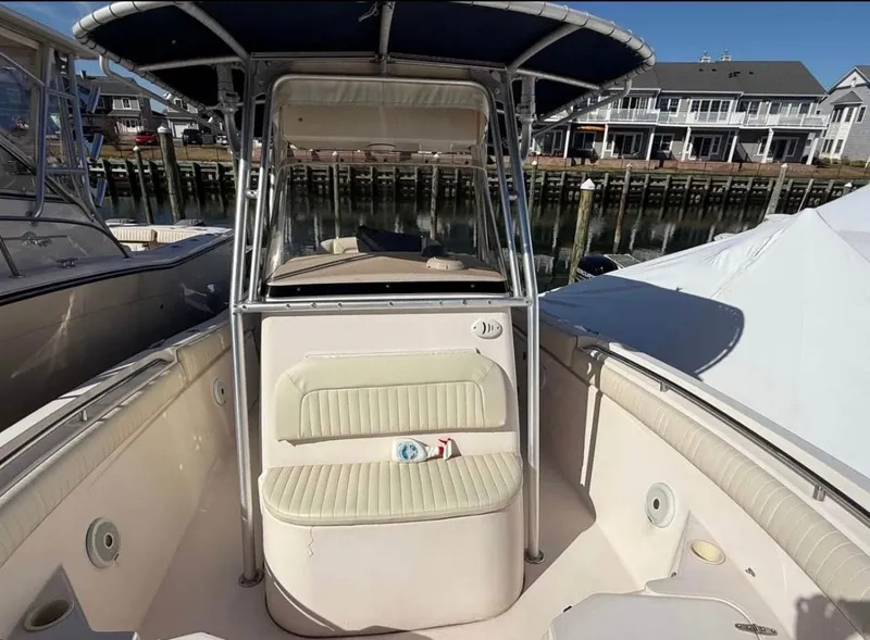 Slide: The Image of 2005 Grady-White Release 283 boat with seating, docked near waterfront homes. - 6