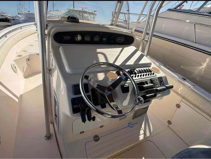 Slide: The Image of 2005 Grady-White Release 283 boat cockpit with steering wheel and control panel. - 7