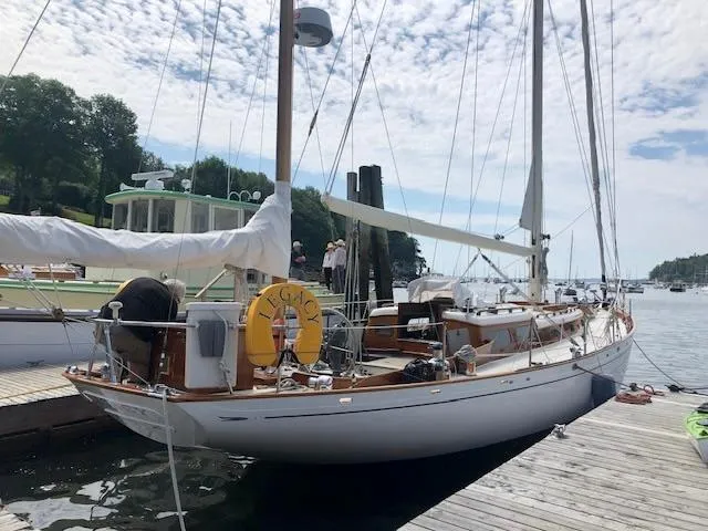 Slide: The Image of Aage Nielsen 50' Yawl, 1956, sailing on calm waters under clear blue sky. - 10