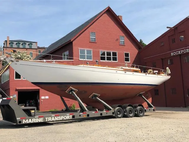 Slide: The Image of 1956 Aage Nielsen 50' Yawl docked at a marina under a partly cloudy sky. - 11