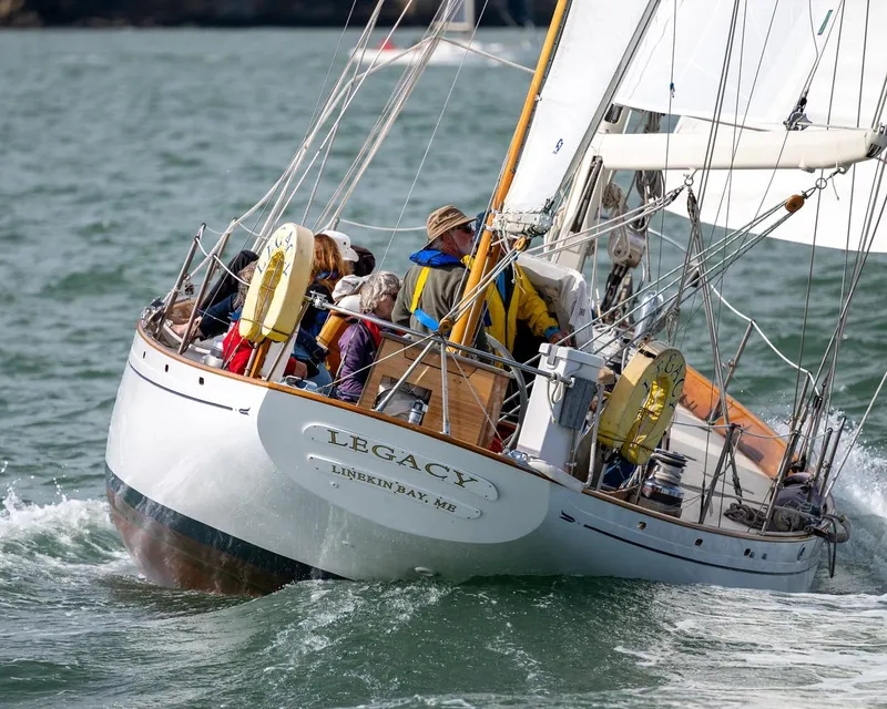 Slide: The Image of Aage Nielsen 1956 50' Ketch sailing on open water, named "Legacy," with crew onboard. - 6