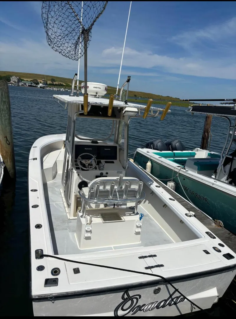 Slide: The Image of 1998 Albemarle 242 Center Console boat docked, featuring fishing equipment and a spacious deck. - 2