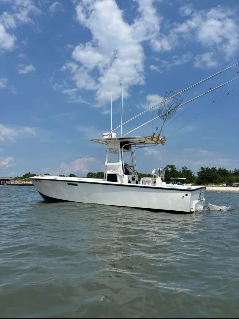 Slide: The Image of 1998 Albemarle 242 Center Console boat on calm water under blue sky. - 3