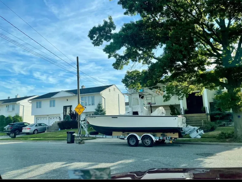 Slide: The Image of 1998 Albemarle 242 Center Console boat on trailer in suburban neighborhood. - 4
