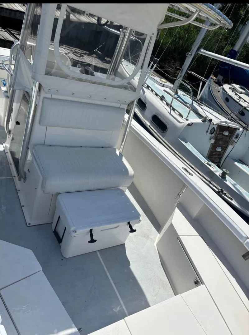Slide: The Image of 1998 Albemarle 242 Center Console boat interior with seating and storage. - 5