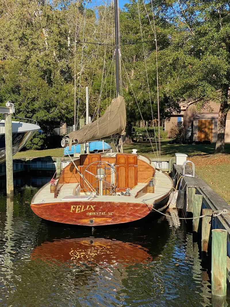 Slide: The Image of 37ft custom catboat yacht docked, Barnegat Bay A-Cat, 2012 model, serene waterside setting. - 16
