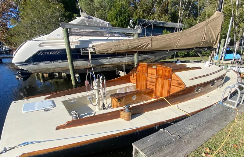 Slide: The Image of 37ft custom catboat yacht, Barnegat Bay A-Cat, docked with sail furled, 2012 model. - 2