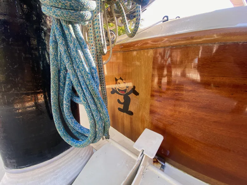 Slide: The Image of 37ft Catboat Yacht with wooden finish and nautical ropes, featuring a playful cat design. - 21