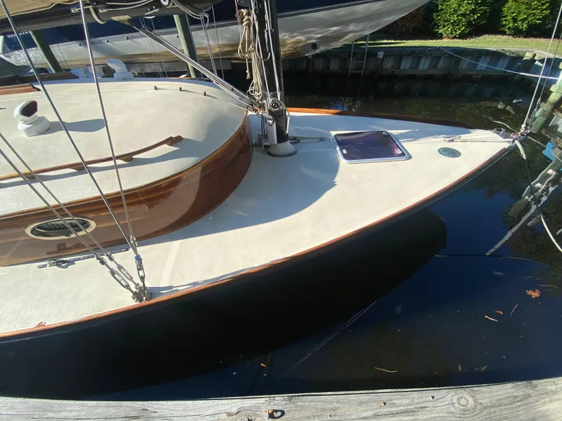 Slide: The Image of 37ft Custom Catboat Yacht, Barnegat Bay A-Cat, docked, showcasing elegant deck design. - 23